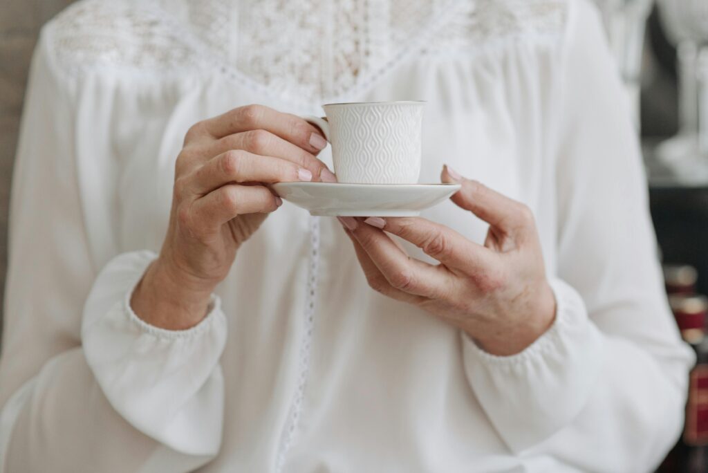 pexels-photo-6873928-6873928 Close-Up Shot of a Person Holding a Cup of Tea on a Saucer